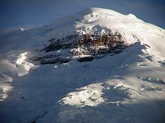 Ecuador Cotopaxi 02-13 Cotopaxi From Tambopaxi At Sunset Close Up Here is a close up of Cotopaxis north face seen from Tambopaxi near sunset. The enormous black rock amidst the white snow is called, 